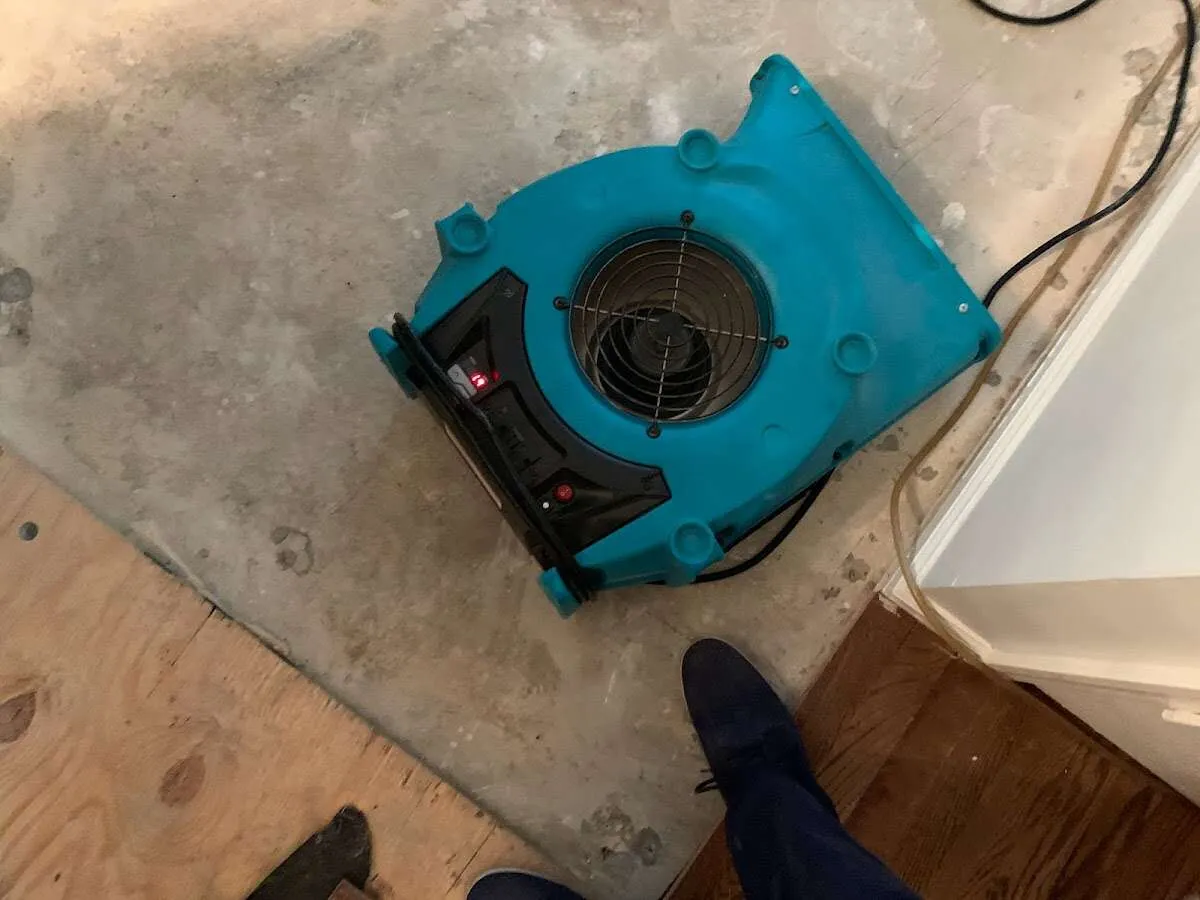 Air mover drying subfloor during Leak Detection & Repair in Boone